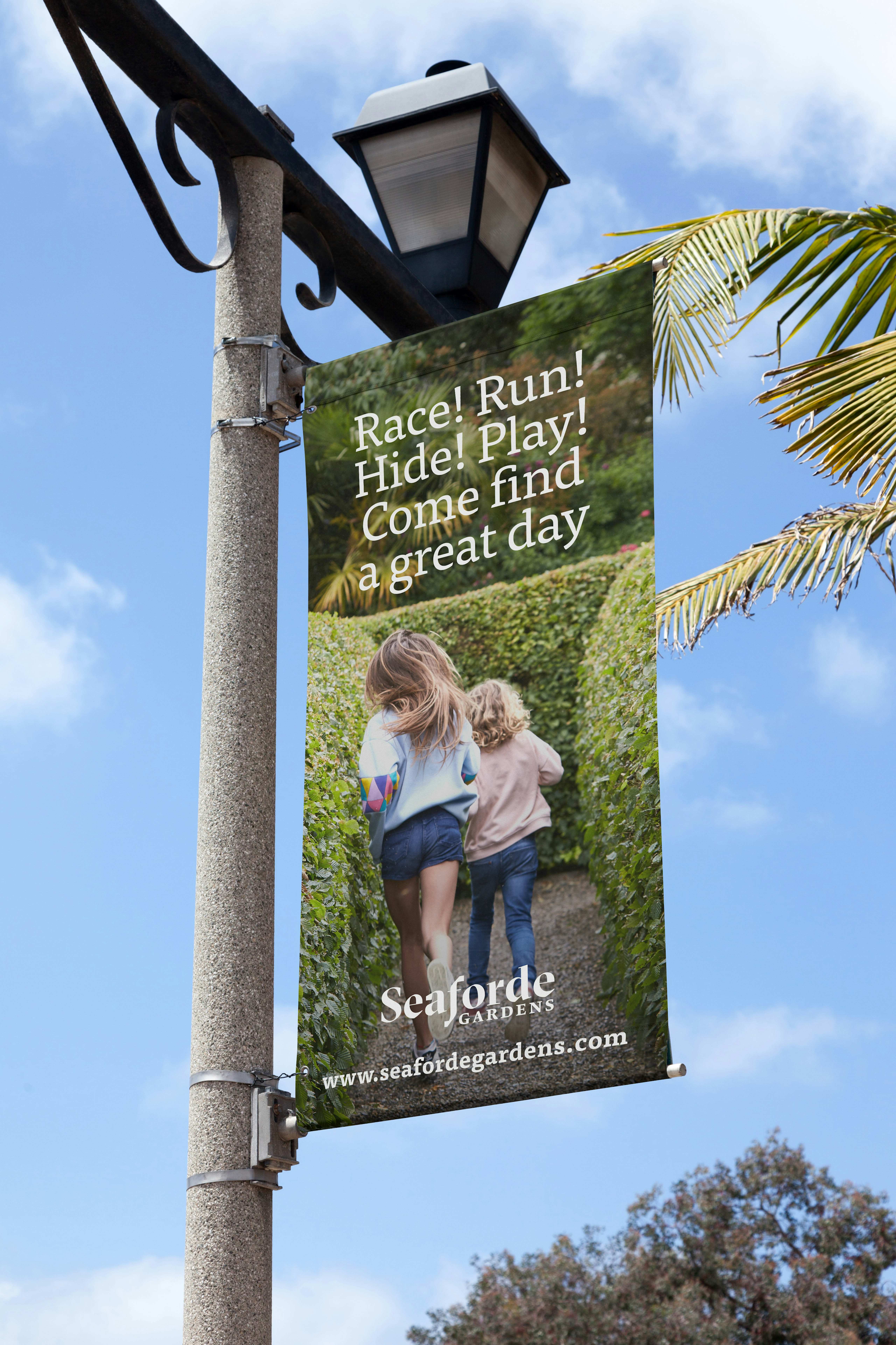 Printed vinyl runner advertising Seaforde Gardens hanging from a tall concrete street lamp.