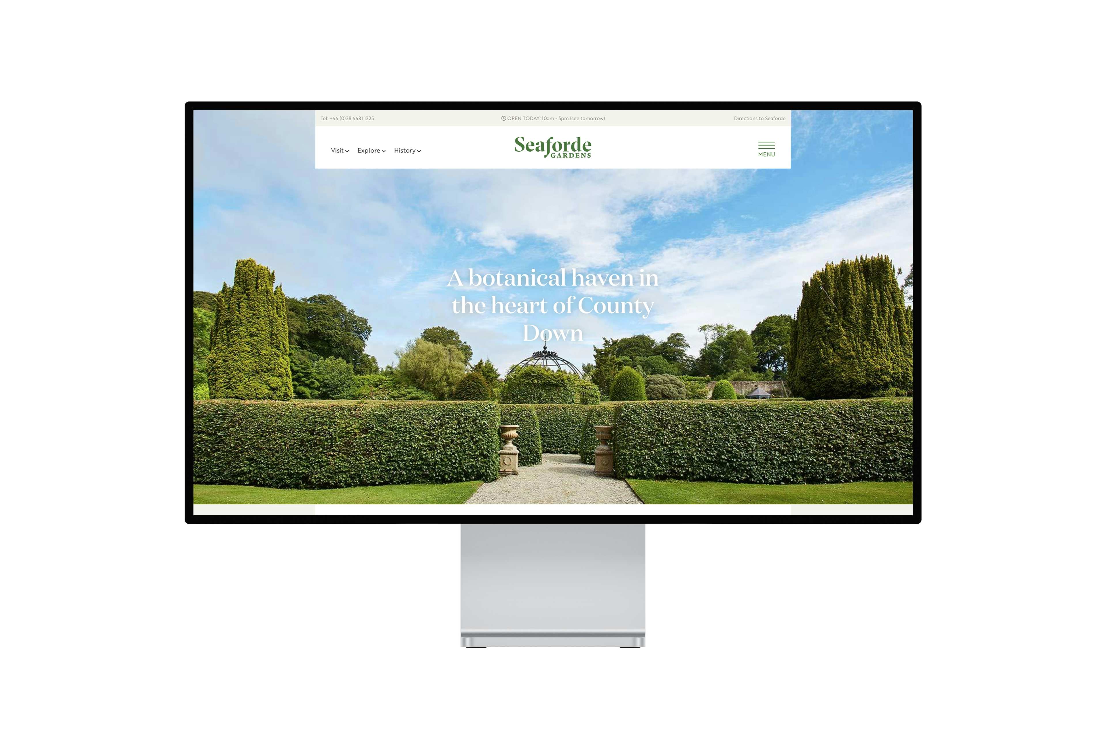 Apple desktop monitor with the Seaforde Gardens homepage on screen.