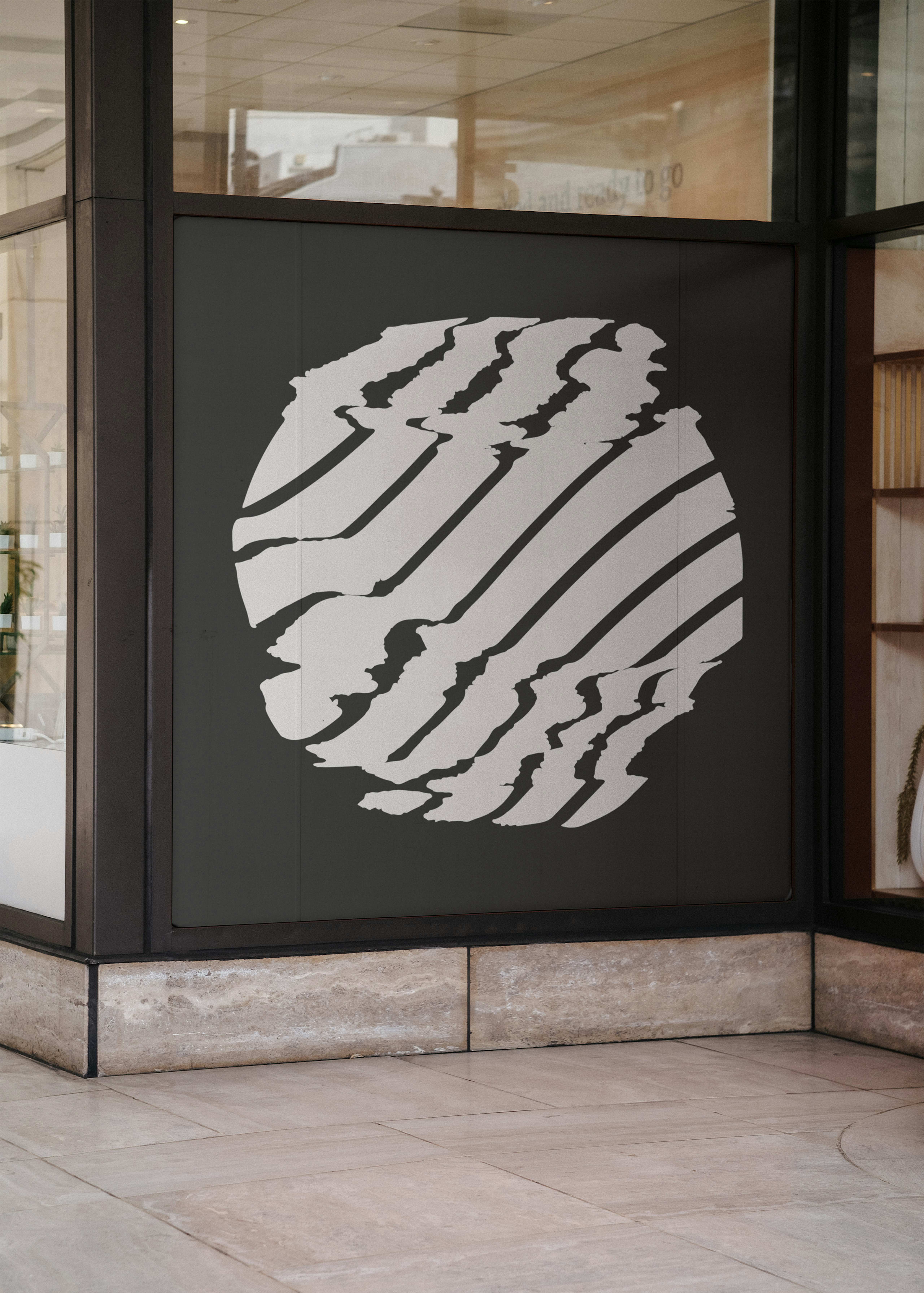 A decorated window with a vinyl covering of the Sonorities Festival 2022 brand mark.