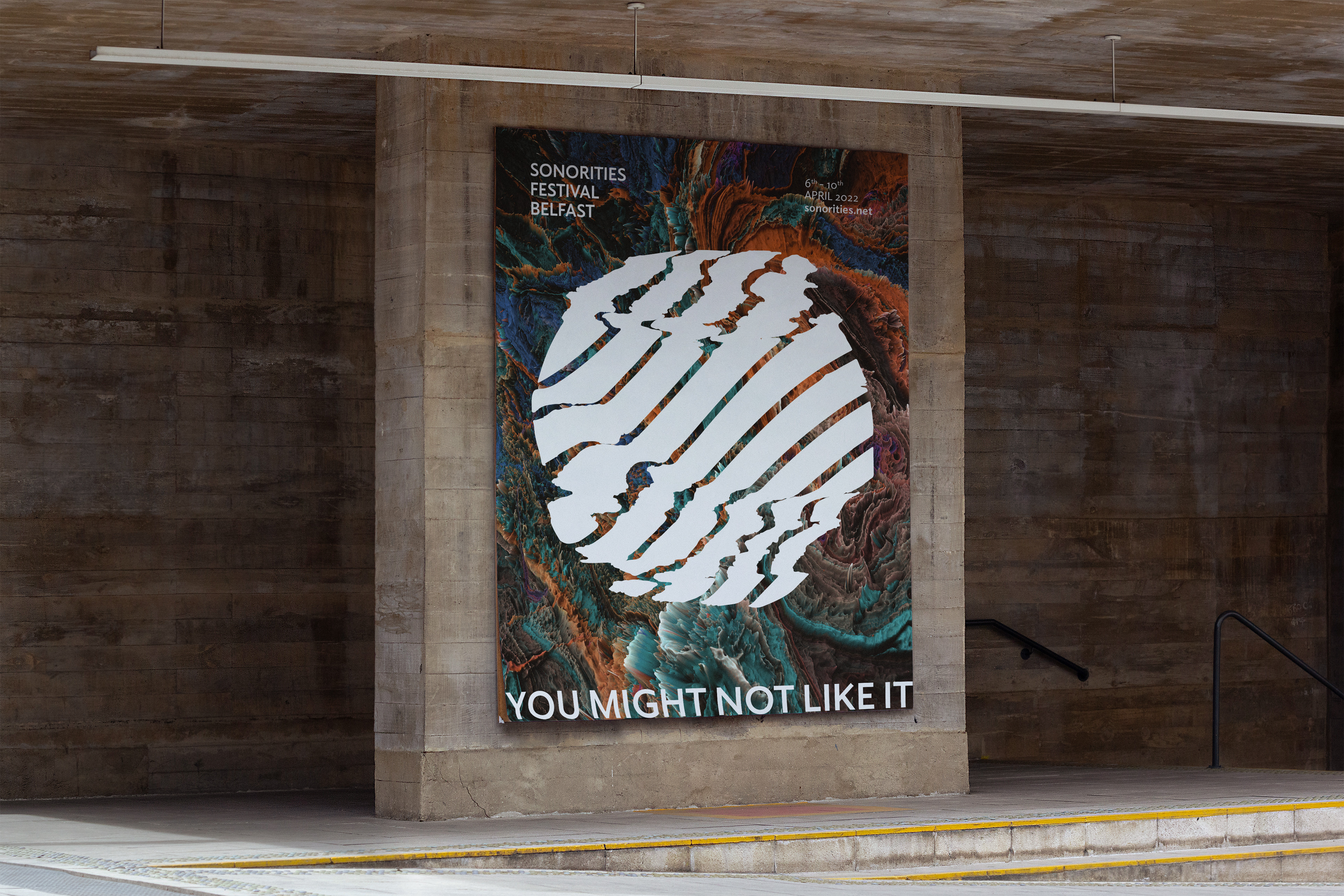 A large, flat concrete pillar with an oversized poster for the Sonorities Festival 2022.