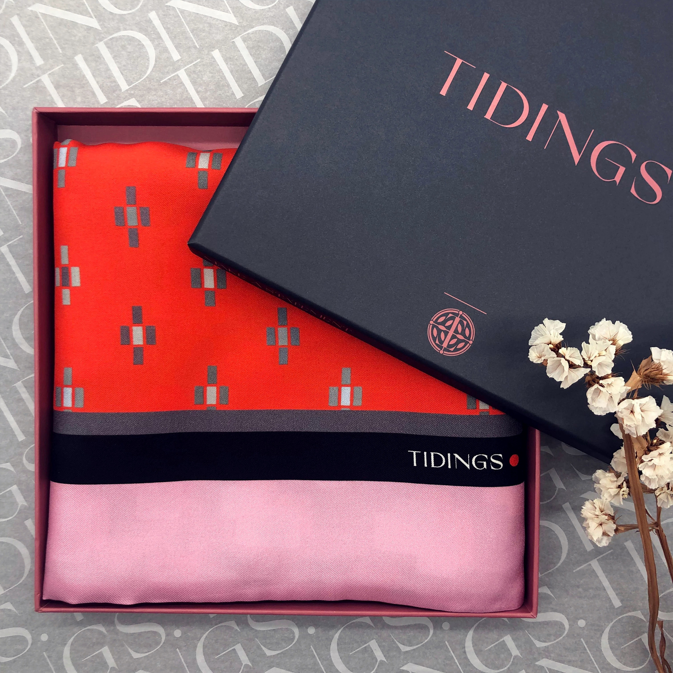Navy box with brightly coloured silk scarf inside.